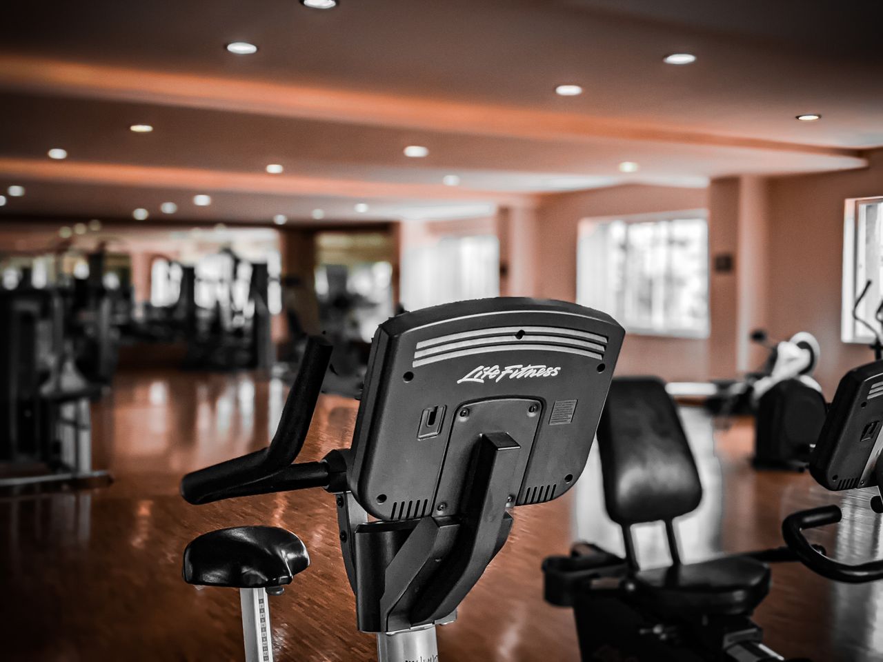 Classes A modern gym interior featuring stationary exercise bikes and equipment for fitness enthusiasts.